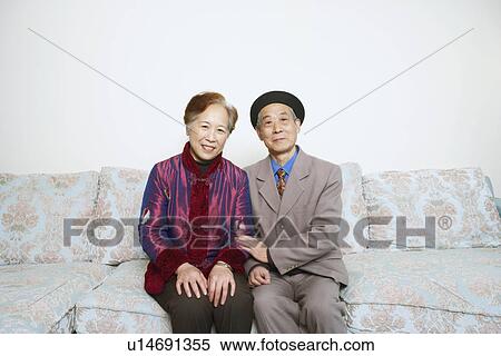 Portrait of a senior man sitting on a couch with a mature woman View Large Photo Image Stock Photography - Portrait of a senior man sitting on a couch with a mature woman. Fotosearch