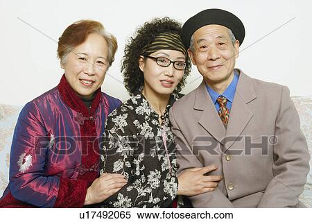 Portrait of a senior man sitting on a couch with two mature women View Large Photo Image Stock Photography - Portrait of a senior man sitting on a couch with two mature women. Fotosearch