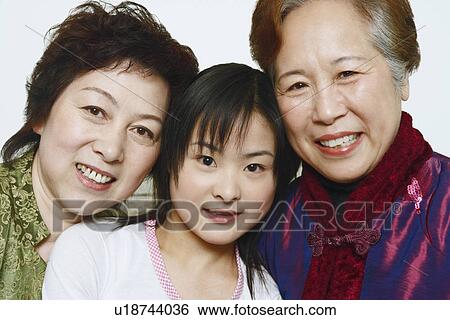 Portrait of a young woman with two mature women smiling View Large Photo Image Stock Photograph - Portrait of a young woman with two mature women smiling. Fotosearch