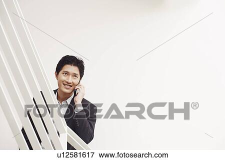 Businessman talking on a mobile phone View Large Photo Image Stock Photo - Businessman talking on a mobile phone. Fotosearch