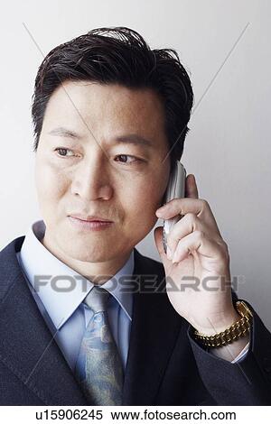 Stock Photography - Close-up of a businessman talking on a mobile phone. Fotosearch