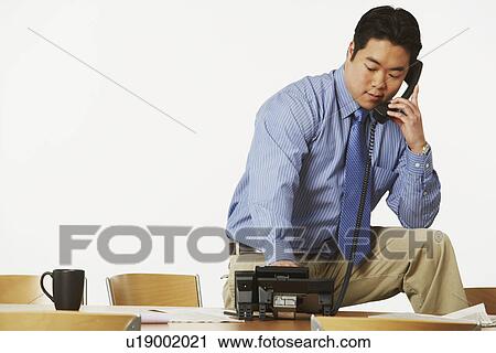 Stock Image - Close-up of a businessman using the telephone. Fotosearch