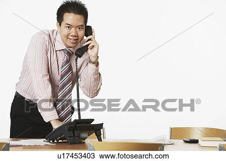 Portrait of a businessman using the telephone View Large Photo Image Stock Image - Portrait of a businessman using the telephone. Fotosearch