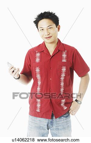 Portrait of a young man holding a mobile phone View Large Photo Image Stock Photo - Portrait of a young man holding a mobile phone. Fotosearch