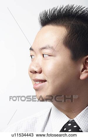 Stock Image - Close-up of a businessman smiling. Fotosearch