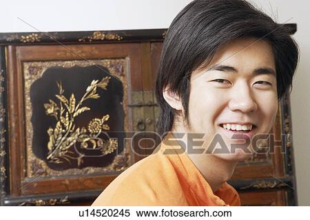 Close-up of a young man smiling View Large Photo Image Stock Photography - Close-up of a young man smiling. Fotosearch