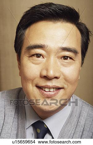 Picture - Portrait of a businessman smiling. Fotosearch