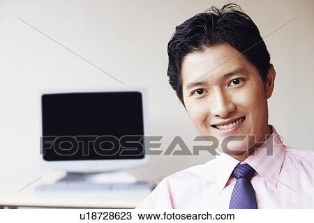 Portrait of a businessman smiling View Large Photo Image Stock Image - Portrait of a businessman smiling. Fotosearch