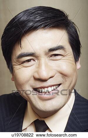 Stock Image - Portrait of a businessman smiling. Fotosearch