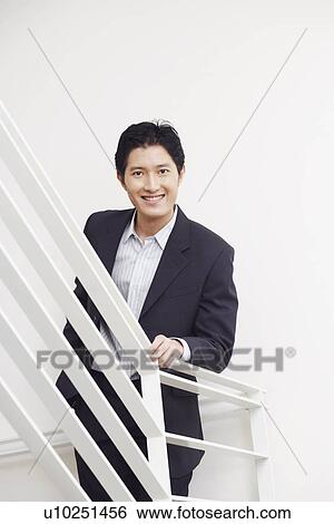Stock Photograph - Portrait of a businessman smiling. Fotosearch