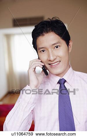 Portrait of a businessman talking on a mobile phone and smiling View Large Photo Image Stock Photo - Portrait of a businessman talking on a mobile phone and smiling. Fotosearch