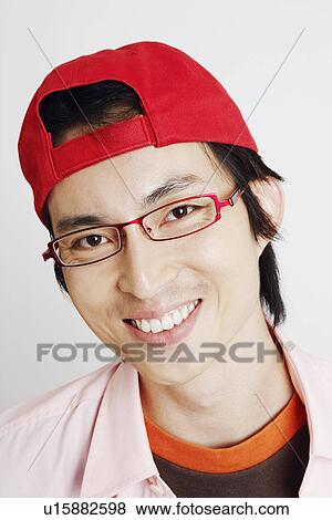 Stock Photo - Portrait of a mid adult man smiling and wearing eyeglasses. Fotosearch
