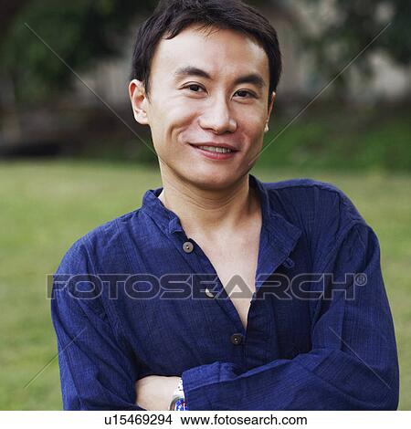 Portrait of a mid adult man smiling with his arms crossed View Large Photo Image Picture - Portrait of a mid adult man smiling with his arms crossed. Fotosearch