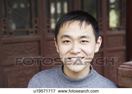 Stock Photo - Portrait of a young man smiling. Fotosearch