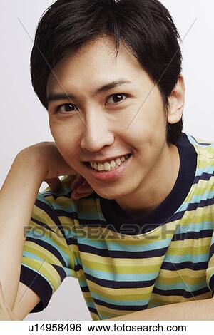 Portrait of a young man smiling View Large Photo Image Stock Photograph - Portrait of a young man smiling. Fotosearch