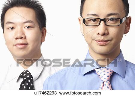 Stock Image - Portrait of two businessmen smiling. Fotosearch