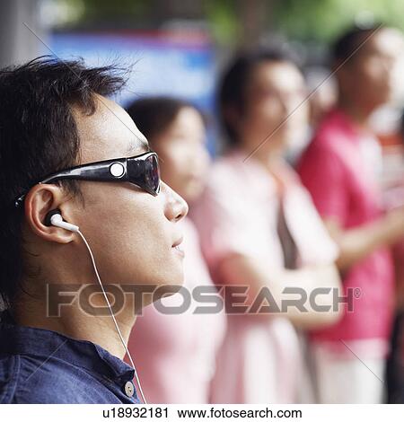 Close-up of a mid adult man listening to music View Large Photo Image Stock Image - Close-up of a mid adult man listening to music. Fotosearch