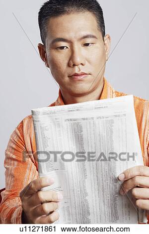 Close-up of a mid adult man reading a newspaper View Large Photo Image Stock Image - Close-up of a mid adult man reading a newspaper. Fotosearch