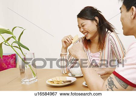Close-up of a young woman and a mid adult man smiling View Large Photo Image Stock Photo - Close-up of a young woman and a mid adult man smiling. Fotosearch