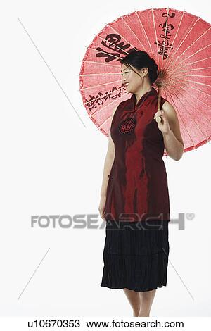 Mid adult woman holding a parasol View Large Photo Image Stock Image - Mid adult woman holding a parasol. Fotosearch