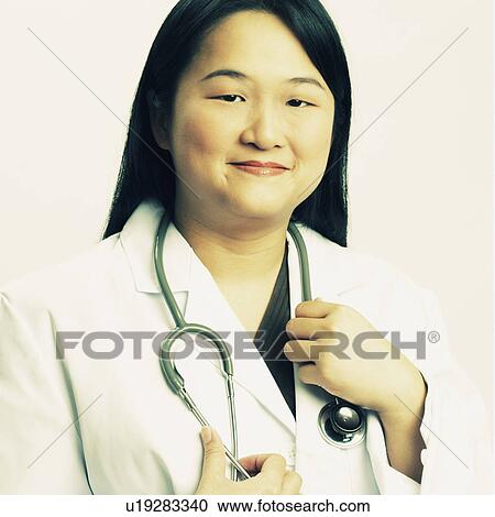 Stock Image - Portrait of a female doctor smiling. Fotosearch