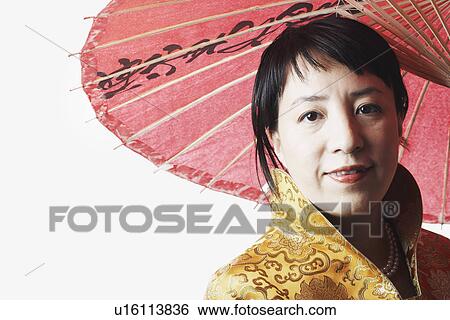 Portrait of a mid adult woman holding a parasol View Large Photo Image Stock Photograph - Portrait of a mid adult woman holding a parasol. Fotosearch