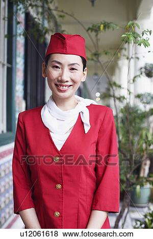 Stock Photo - Portrait of an air stewardess smiling. Fotosearch