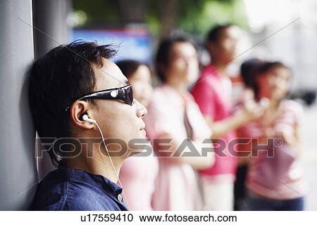 Close-up of a mid adult man listening to music View Large Photo Image Stock Image - Close-up of a mid adult man listening to music. Fotosearch