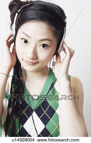 Picture - Close-up of a teenage girl listening to music. Fotosearch