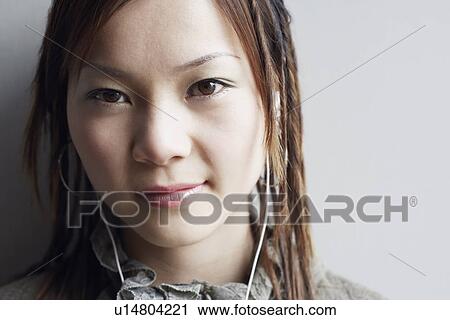 Portrait of a young woman listening to music View Large Photo Image Stock Image - Portrait of a young woman listening to music. Fotosearch