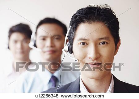 Portrait of three male customer service representatives View Large Photo Image Stock Photo - Portrait of three male customer service representatives. Fotosearch
