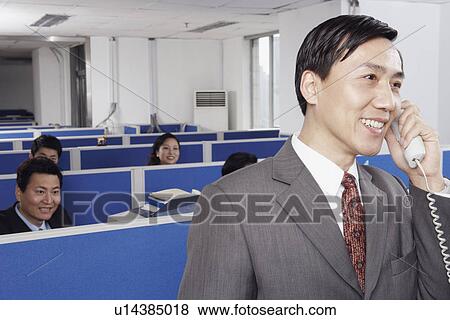 Stock Photo - Business executives working in an office. Fotosearch