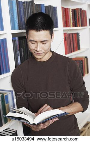 Picture - Close-up of a businessman reading a book. Fotosearch