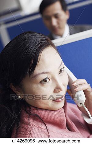 Stock Photograph - High angle view of a businesswoman talking on the telephone. Fotosearch