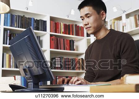 Stock Photograph - Low angle view of a businessman using a computer. Fotosearch