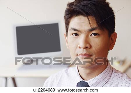 Stock Photo - Portrait of a businessman in an office. Fotosearch