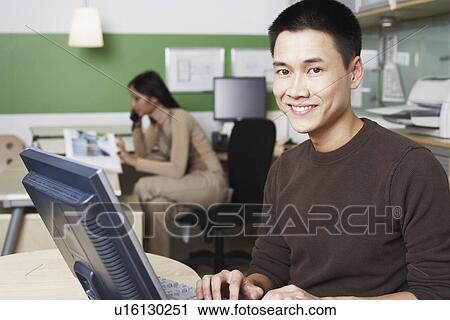 Stock Image - Portrait of a businessman using a computer. Fotosearch