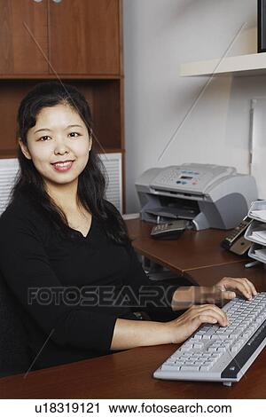 Stock Image - Portrait of a businesswoman using a computer. Fotosearch