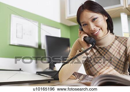 Portrait of a businesswoman using a telephone View Large Photo Image Stock Photograph - Portrait of a businesswoman using a telephone. Fotosearch