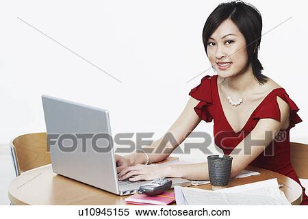 Stock Photography - Portrait of a businesswoman using a laptop. Fotosearch