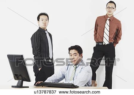 Stock Photo - Portrait of three businessmen in an office. Fotosearch