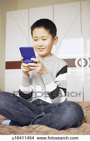 Picture - Boy playing a video game. Fotosearch