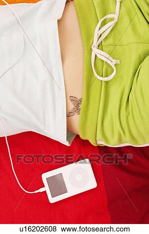 Stock Photo - Mid section view of a woman with an MP3 player. Fotosearch