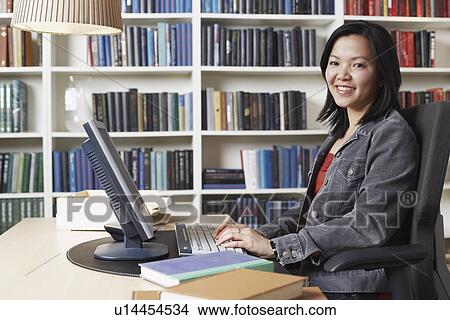 Portrait of a businesswoman using a computer View Large Photo Image Picture - Portrait of a businesswoman using a computer. Fotosearch