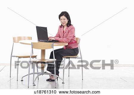 Stock Image - Portrait of a businesswoman using a laptop. Fotosearch