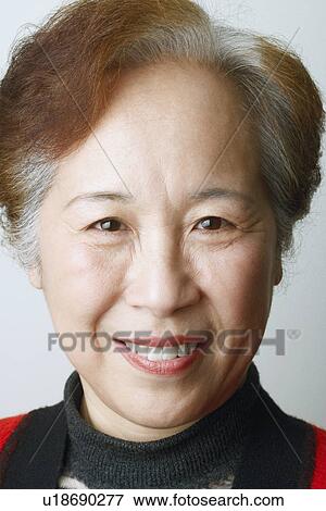 Close-up of a mature woman smiling View Large Photo Image Stock Photo - Close-up of a mature woman smiling. Fotosearch