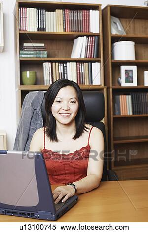Portrait of a businesswoman using a laptop smiling View Large Photo Image Stock Photography - Portrait of a businesswoman using a laptop smiling. Fotosearch