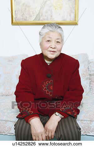 Portrait of a senior woman sitting on a couch View Large Photo Image Stock Photograph - Portrait of a senior woman sitting on a couch. Fotosearch