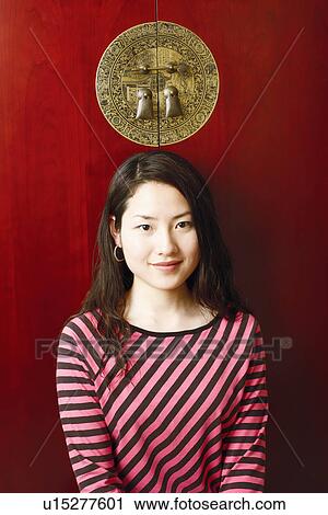 Stock Image - Portrait of a young woman smiling. Fotosearch