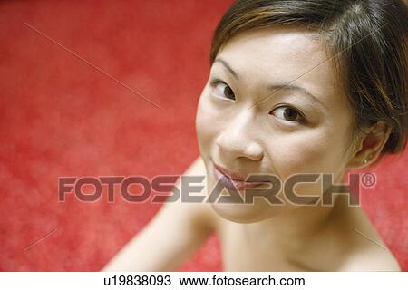 Stock Image - Portrait of a young woman smiling. Fotosearch